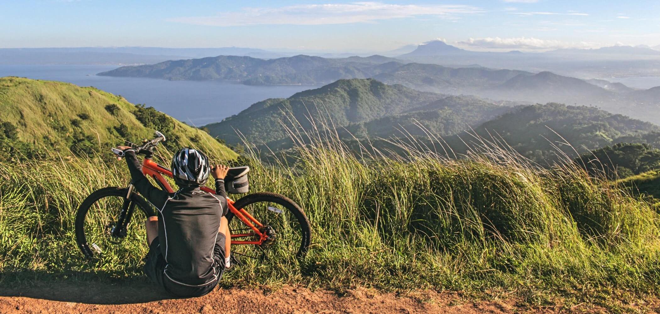 Cyclist riding through remote terrain on a luxurious multi-day expedition.
